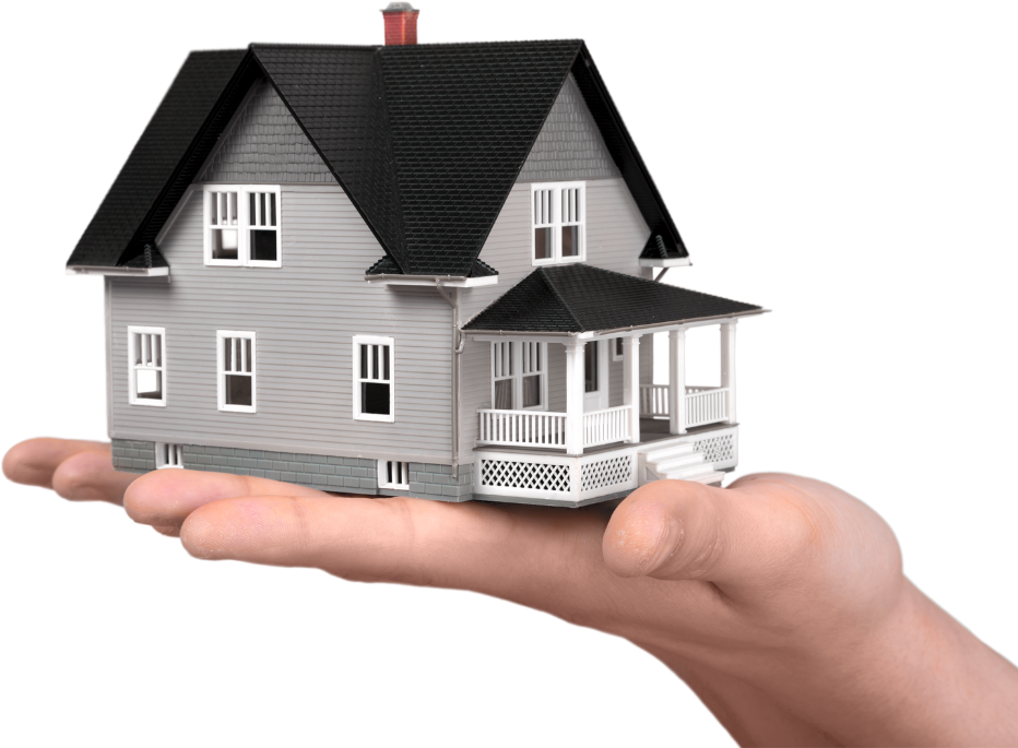 A hand holding a model house, representing home investment